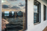Reflection : A man is looking out of the window on a ferryboat, Istanbul