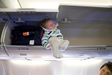 Overhead : Traveling in an airplane with the baby in the overhead compartment.