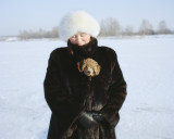 People in the dunes7 : Olga with her dog on frozen Bullupe river, 2012. “People in the dunes” project explores the borders between urban and wild nature around Bolderāja and Daugavgrīva districts, which are located in the periphery of Riga, few kilometers away from the Gulf of Riga. After World War II, the fishing villages build on the dunes were replaced with blockhouses and some parts of Daugavgrīva became a closed military area.  Now 23 years have passed, but the mainly Russian-speaking population of the area is still haunted by the shadows of the Soviet past.