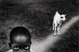 0°30’38.981″ N, 32°46’25.948″ E - Angela : Angela is 10 years old and after she gets out of school, she often puts 7 goats out to pasture. Her family trades milk and cheese for meat and sugar - 0°30’38.981″ N, 32°46’25.948″ E is a work about an unknown and unnamed African community.Not under a central government,many African communities believe nature is able to regulate itself and that a modern human society has to be built around it.My work is focused on one of this community where everything belongs to everyone and the community seems to act in the common interests,so its development is gradual and sustainable.A collective intelligence connects human being,animals and plants.The full benefits associated with the balanced use of natural resources include natural,social,human,physical and financial values:food as well as a source of income which enables inhabitants to send children to school and pay for their health care.