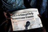Life after Kony : The story of  thousands of victims that lost lives, dignity and hope in Northern Uganda due the endless war  - 1987 | 2006 -  between the LRA, the Lord’s Resistance Army of Joseph Kony and the official UPDF troops.…no real justice, recognition, acceptance, help and compensation seem to be in view. Victim holding a newspaper publication.
