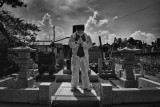 Mister Matsumoto, Yakuza member and Tepco contractor is praying on his family grave, Fukushima "No-Go Zone", Japan. :