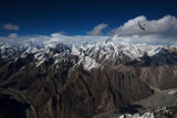 Paragliding Pakistan (4 of 7) : Argentinean pilot Hernan Pitocco performs a wingover whilst soaring high above the Karakoram Range.