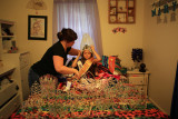 Mary's Pageant : Dana Brunner helps prepare her daughter Mary Brunner, 8, for a portrait in her bedroom surrounded by 57 crowns and sashes which she won at beauty pageants on October 18, 2012. Mary has been entering beauty pageants since the age of 5.